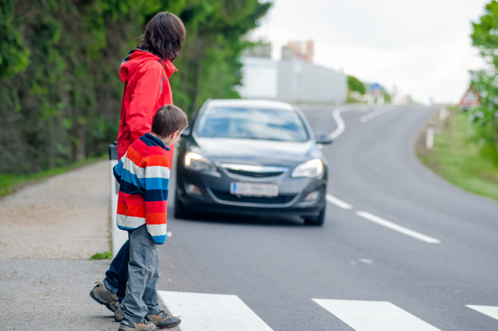 Car driving toward pedestrians crossing crosswalk.- Surprise Pedestrian Accident Lawyers