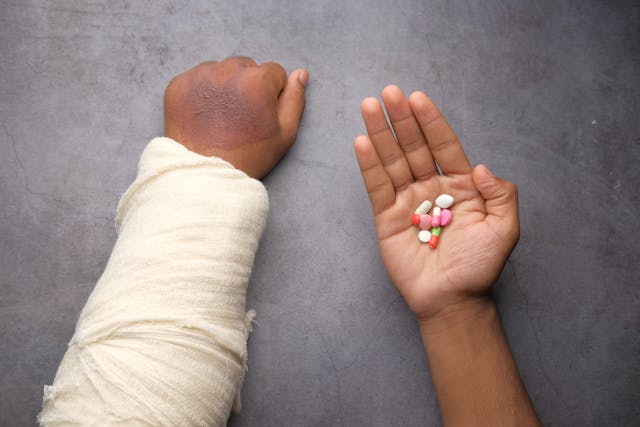 injured person holding medicine - Stockton Personal Injury Lawyers