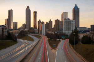 Atlanta skyline with traffic on I-75/I-85 at sunset, symbolizing personal injury claims process in Georgia