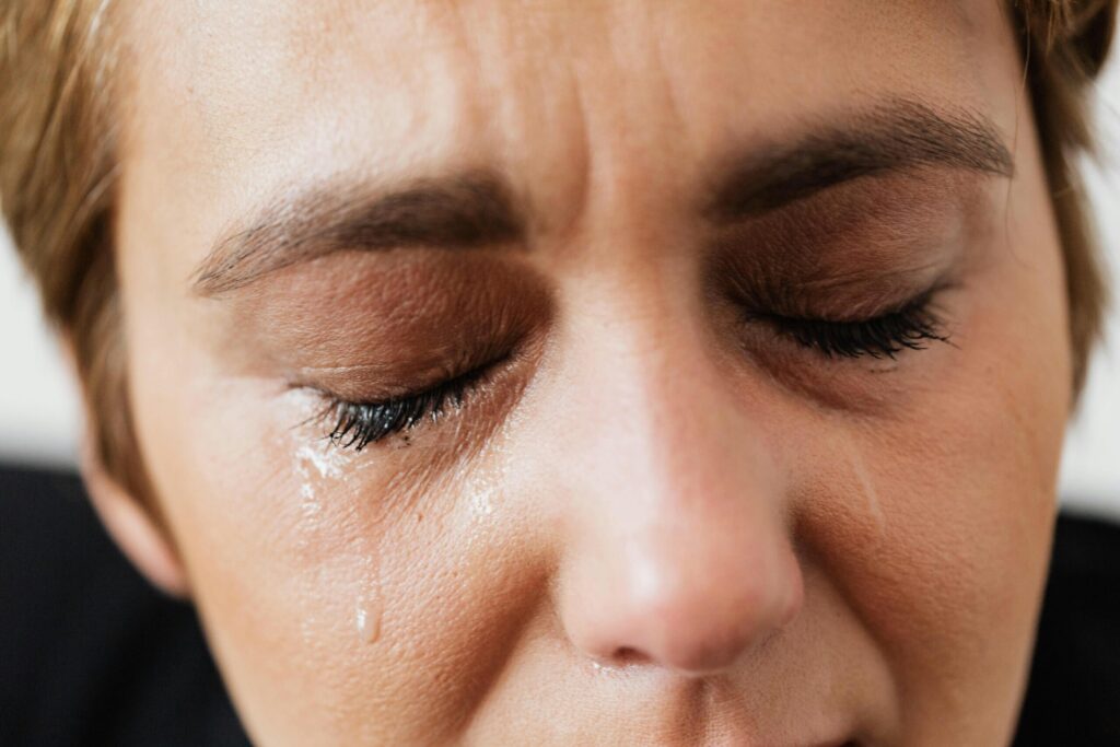 Crying woman after a minor fender bender, illustrating anxiety — should I get a lawyer for a minor car accident?